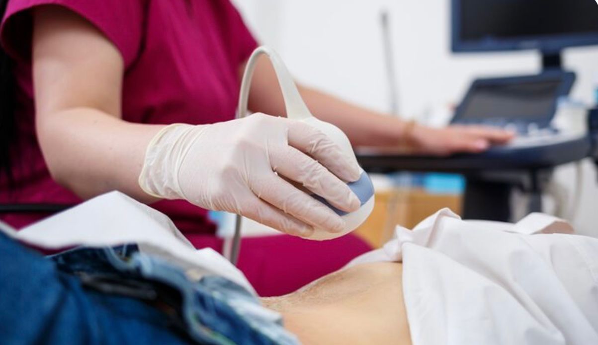 Échographie — sonde appliquée lors d'un examen abdominal
